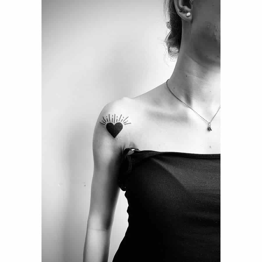 Minimalist black heart tattoo with radiating lines in a sleek and modern design.