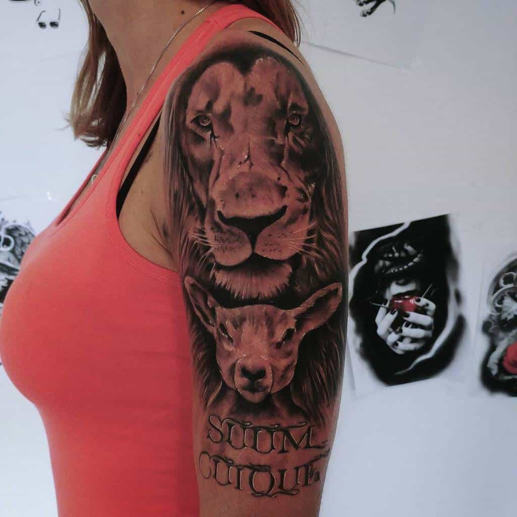 Person with a lion and lamb tattoo on their upper arm, wearing a pink sleeveless shirt, embodies strength and harmony