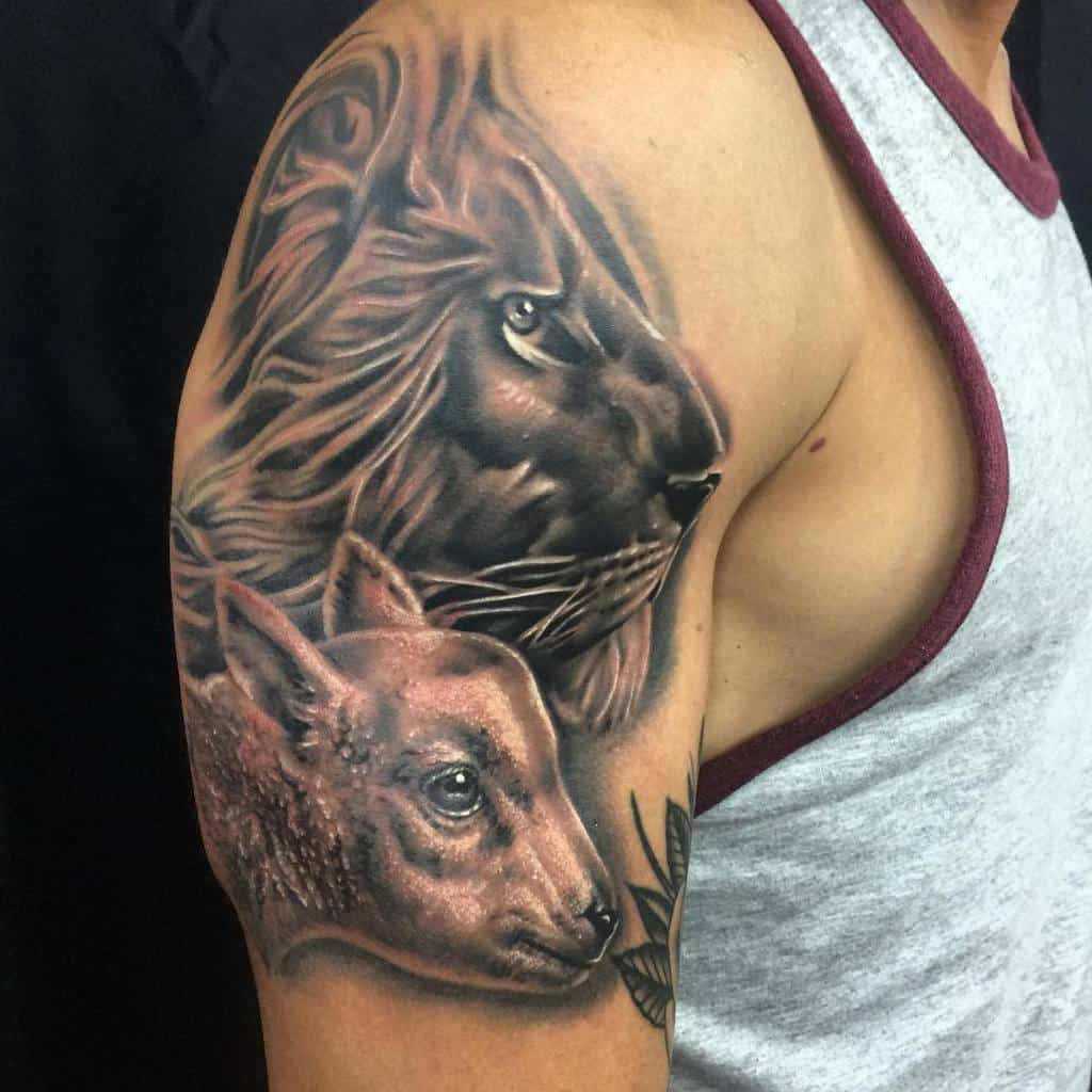 Lion and lamb tattoo on a man's upper arm wearing a sleeveless shirt