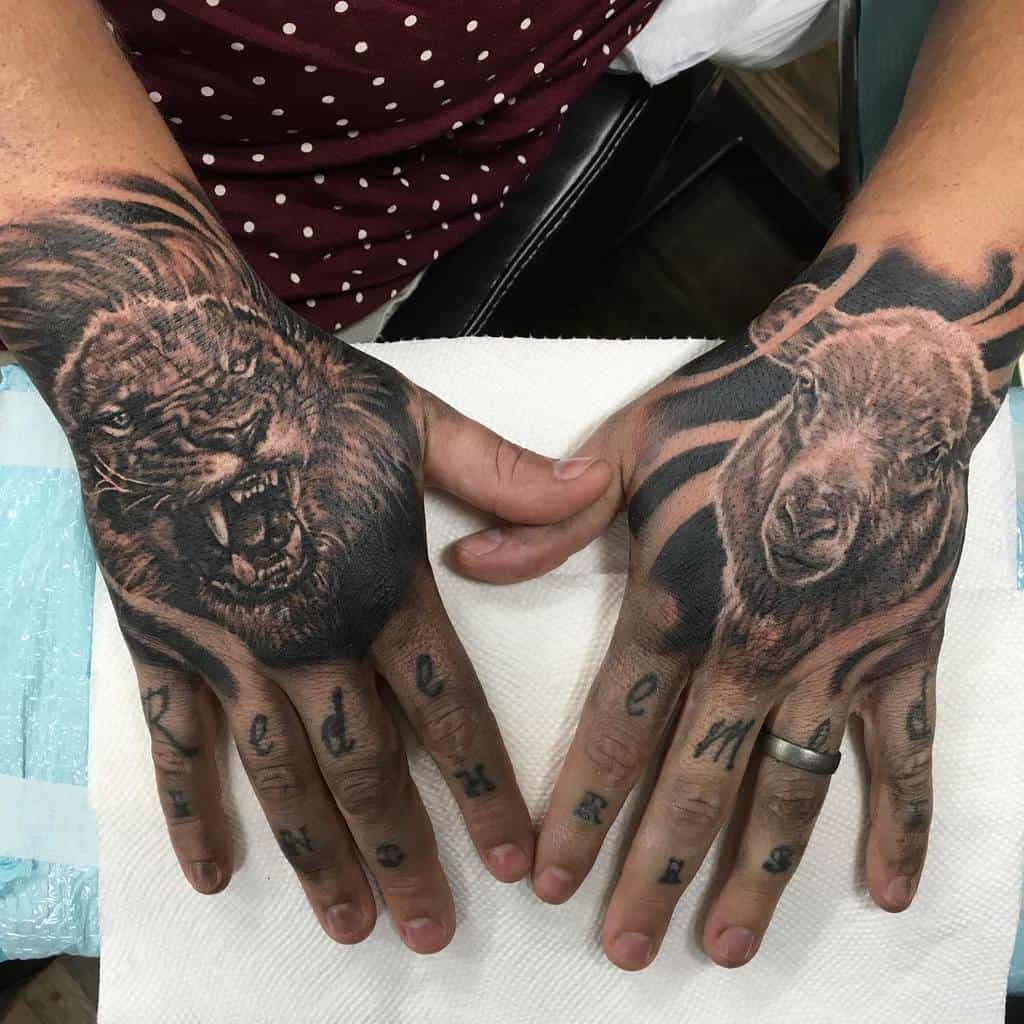Hands with detailed tattoos of a roaring lion on the left and a fierce lamb on the right