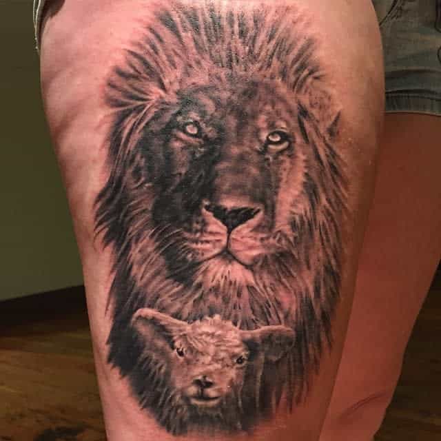 Lion and lamb tattoo on a person's thigh, showcasing serene expressions on both the lion and lamb