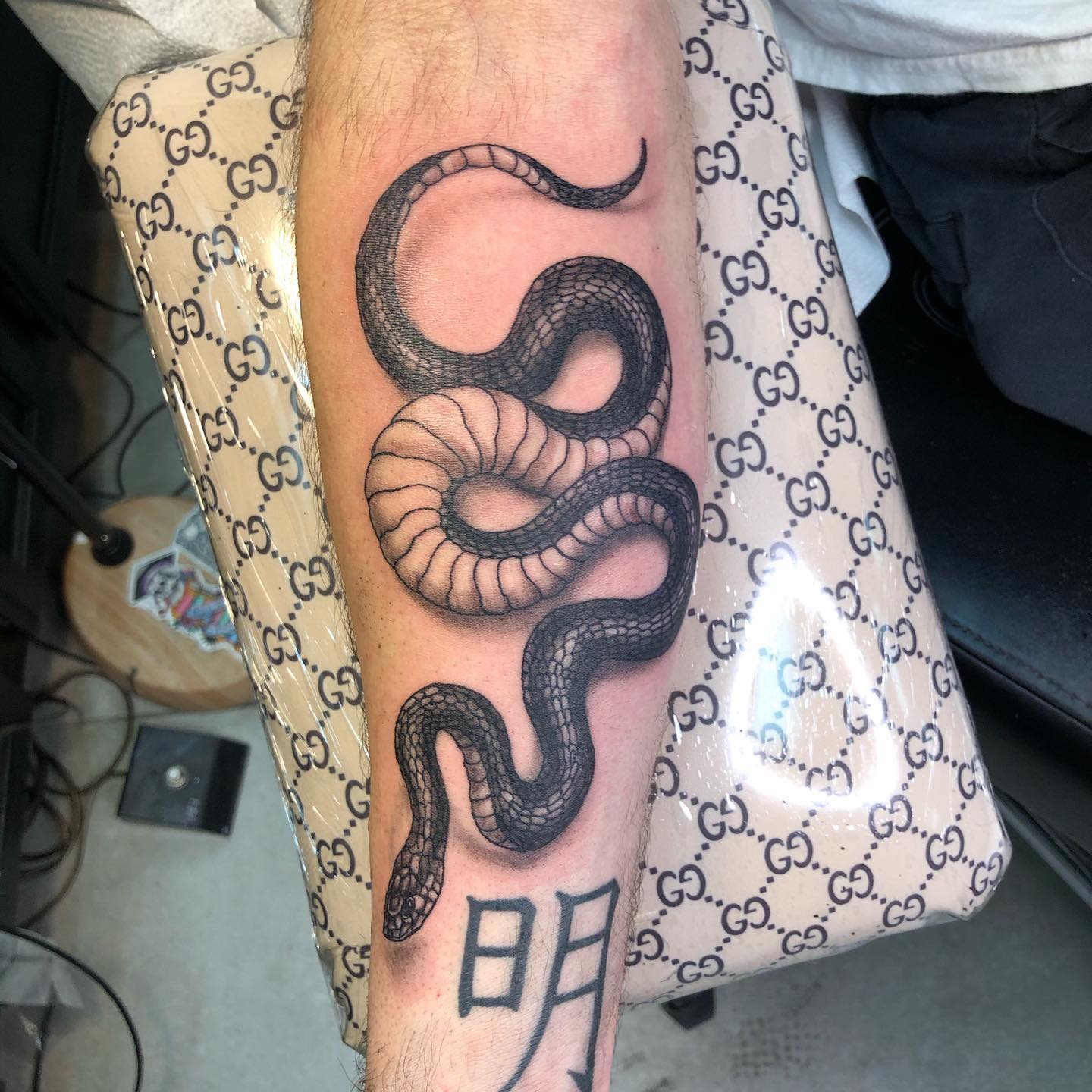 Tattoo of a detailed black mamba on a forearm