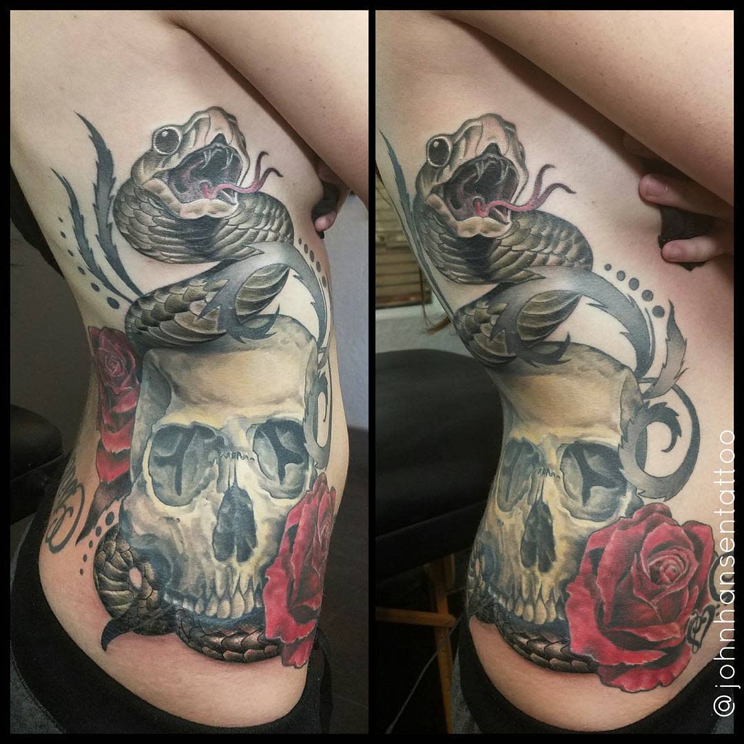 Side tattoo of a skull entwined with a snake, surrounded by red roses