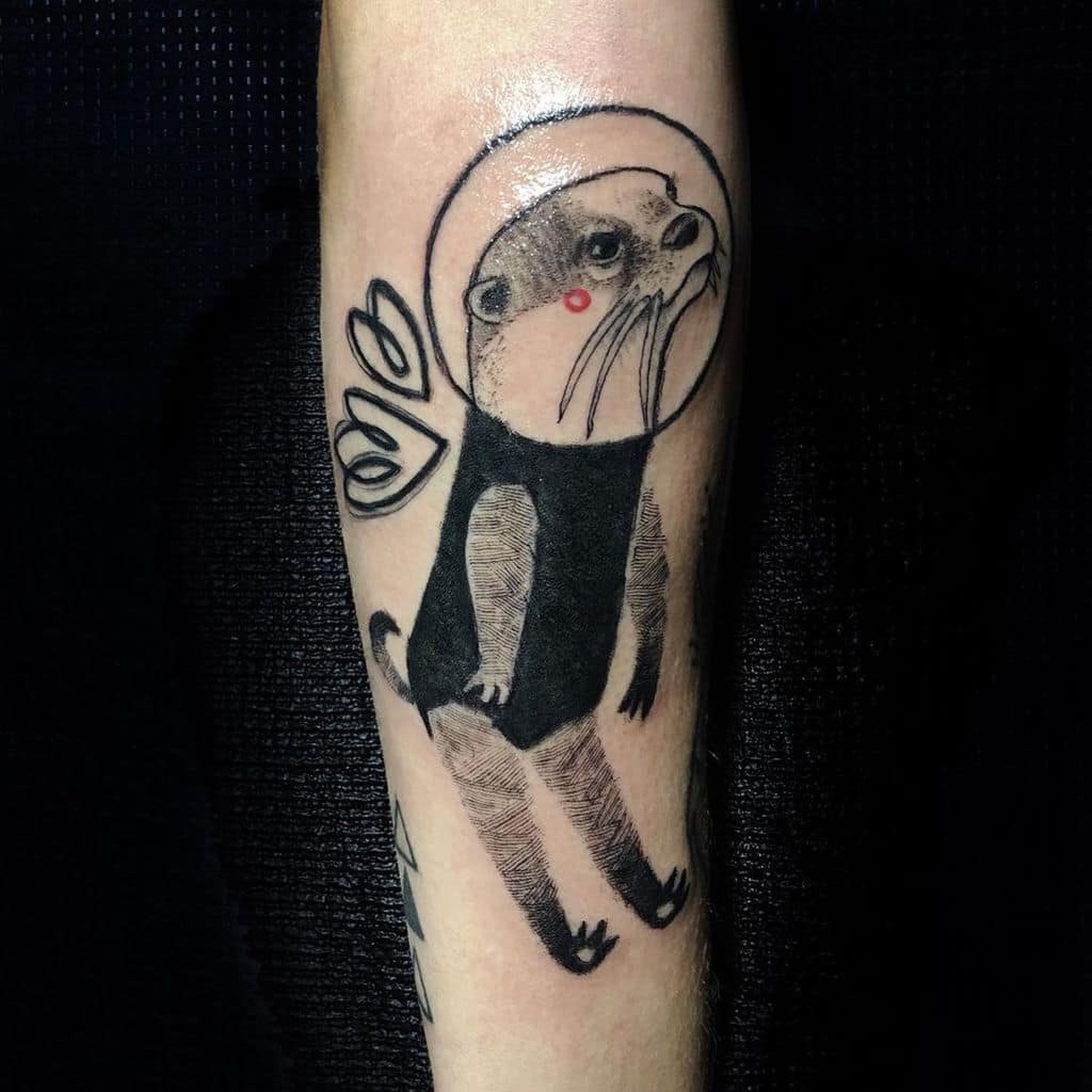 Minimalist otter tattoo wearing a space helmet with wings, blending whimsy and modern design