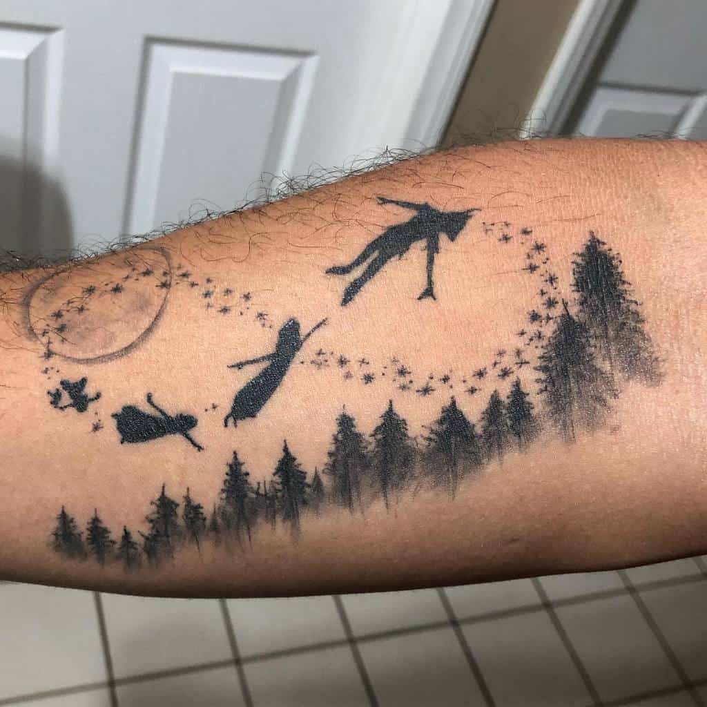Silhouette-style Peter Pan tattoo with him, Wendy, John, and Michael flying over a forest, trailed by pixie dust and a full moon