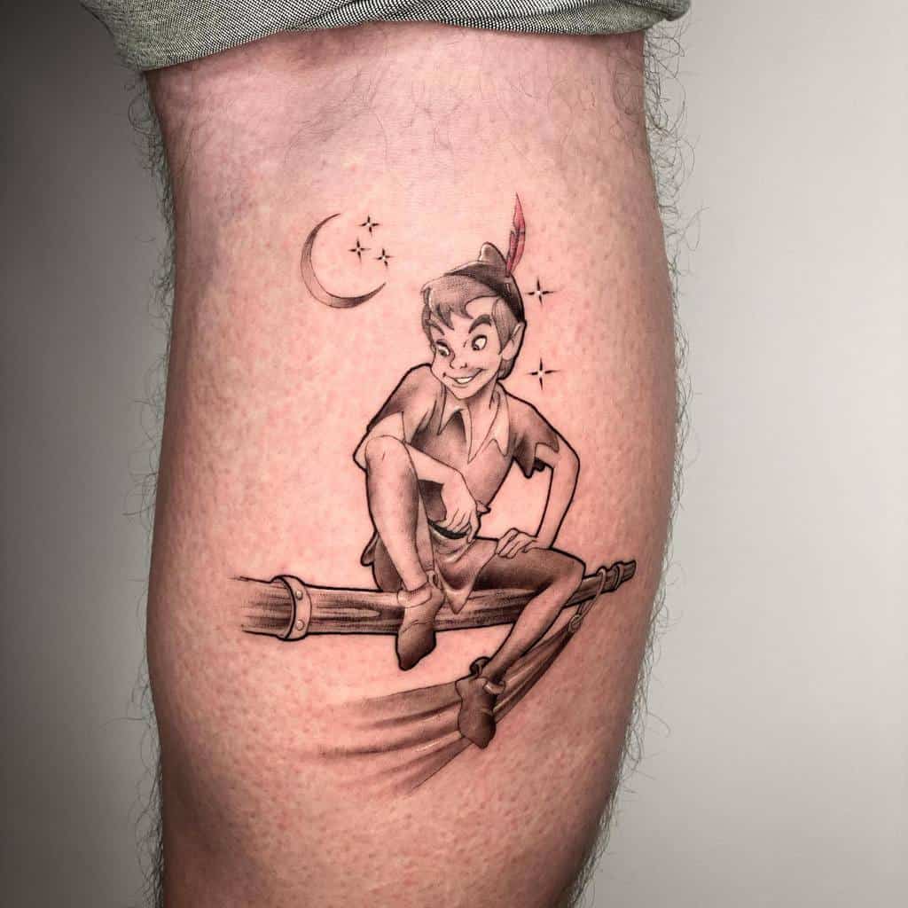 Black and gray Peter Pan tattoo sitting and smiling, with a crescent moon and sparkling stars in the background