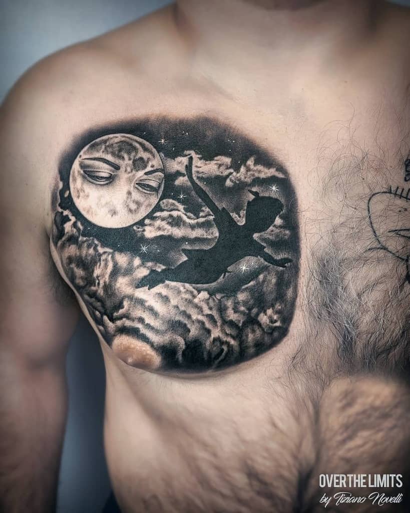 Black and gray tattoo of Peter Pan's silhouette flying among clouds and stars, with a detailed moon featuring a face