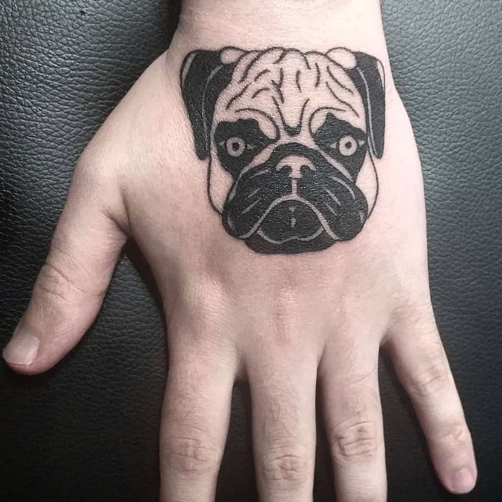 A tattoo of a pug's face, with black ink detailing