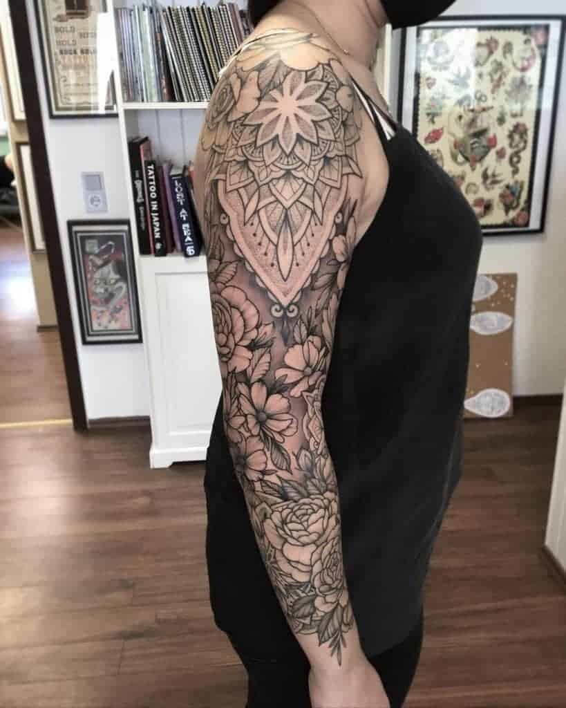 Person with a floral and geometric patterned sleeve tattoo on their right arm