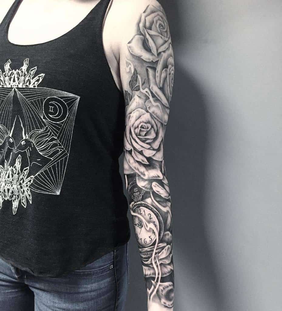 Woman with a full sleeve tattoo of roses and a clock
