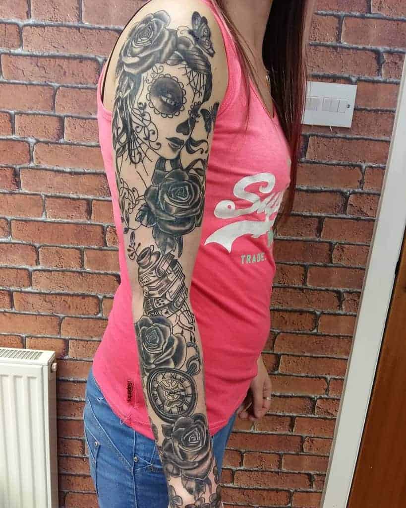 Black and gray tattoo sleeve on the woman's arm