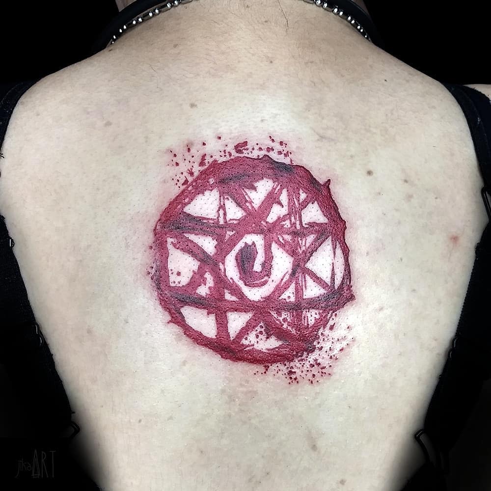 Fullmetal Alchemist tattoo of a blood-red transmutation circle, designed to look raw and hand-drawn