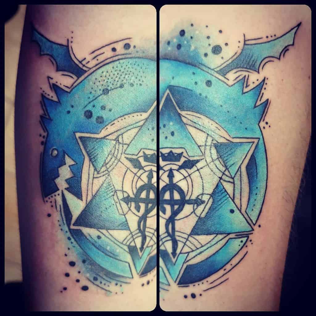 Fullmetal Alchemist tattoo of the Human Transmutation Circle with the Flamel symbol, featuring a bold blue watercolor effect and winged accents