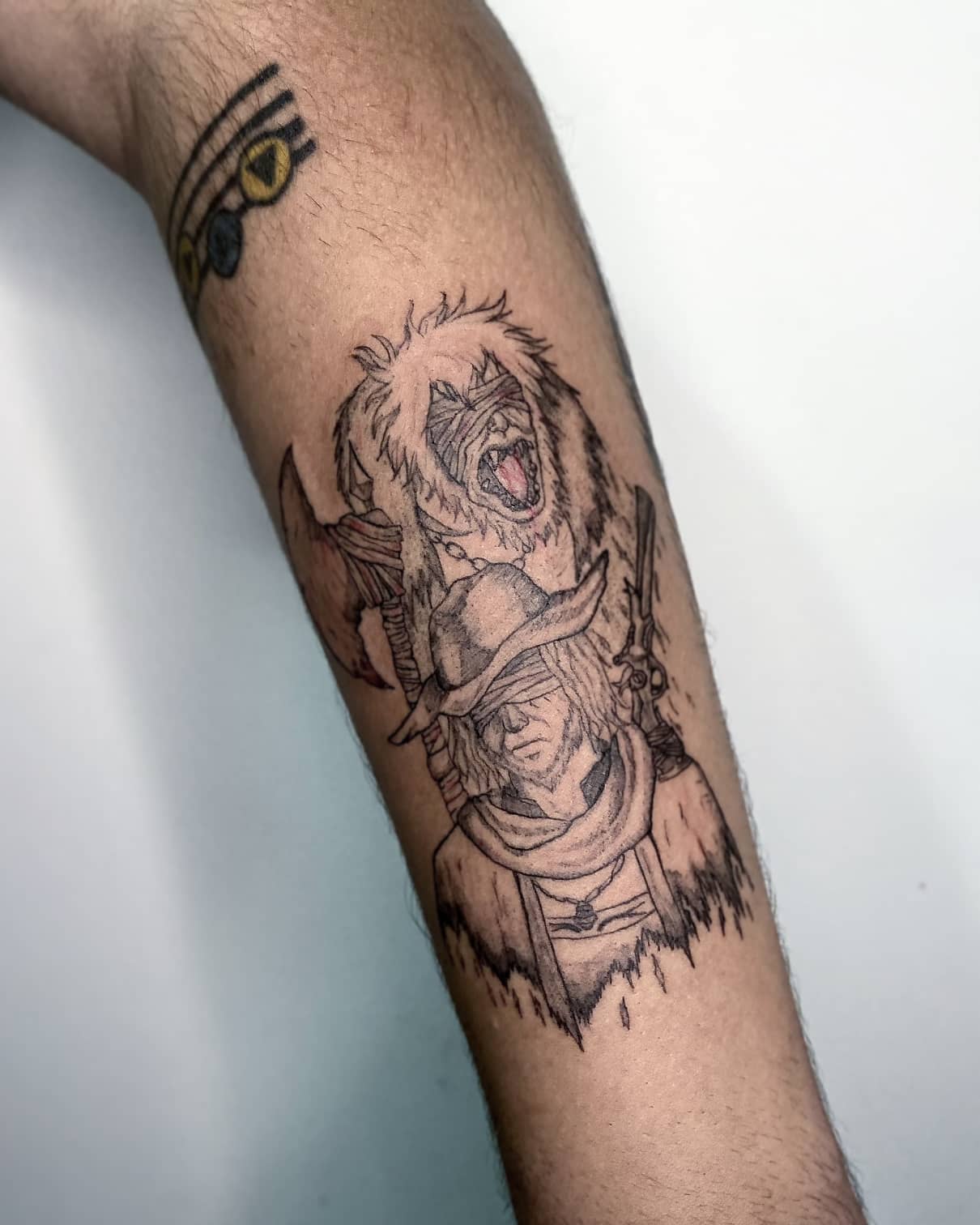 Tattoo featuring a Bloodborne hunter with a snarling creature overhead, capturing the game's essence