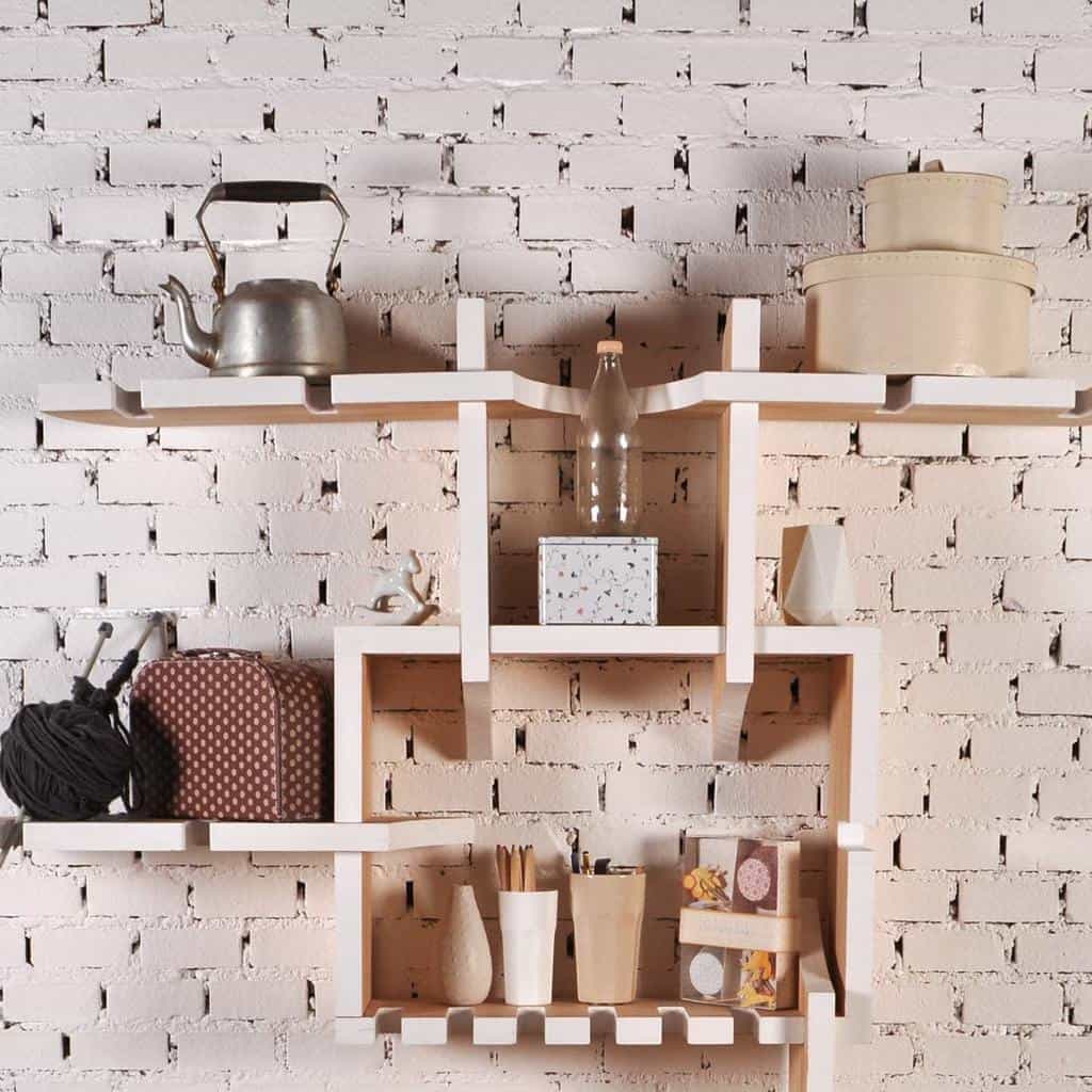 creative wood wall shelf on brick wall