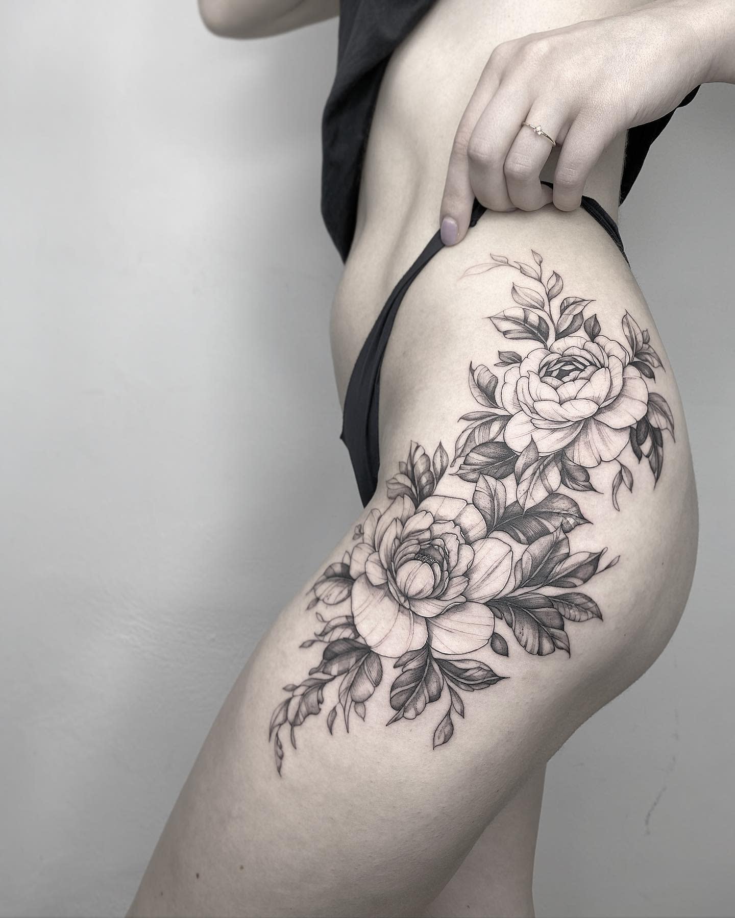 Woman with a peony floral tattoo sleeve