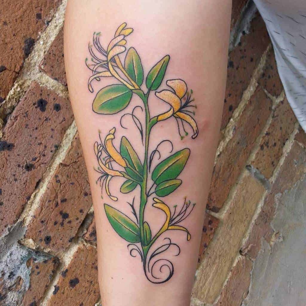 Tattoo of yellow and green honeysuckle vine on the forearm