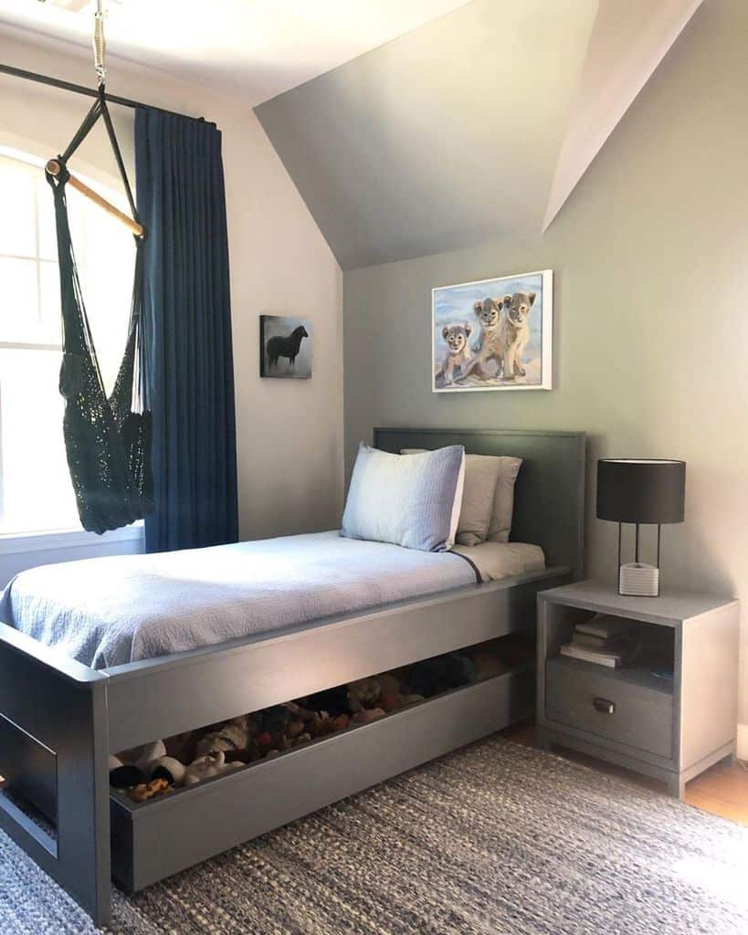gray bed with underneath storage in small room