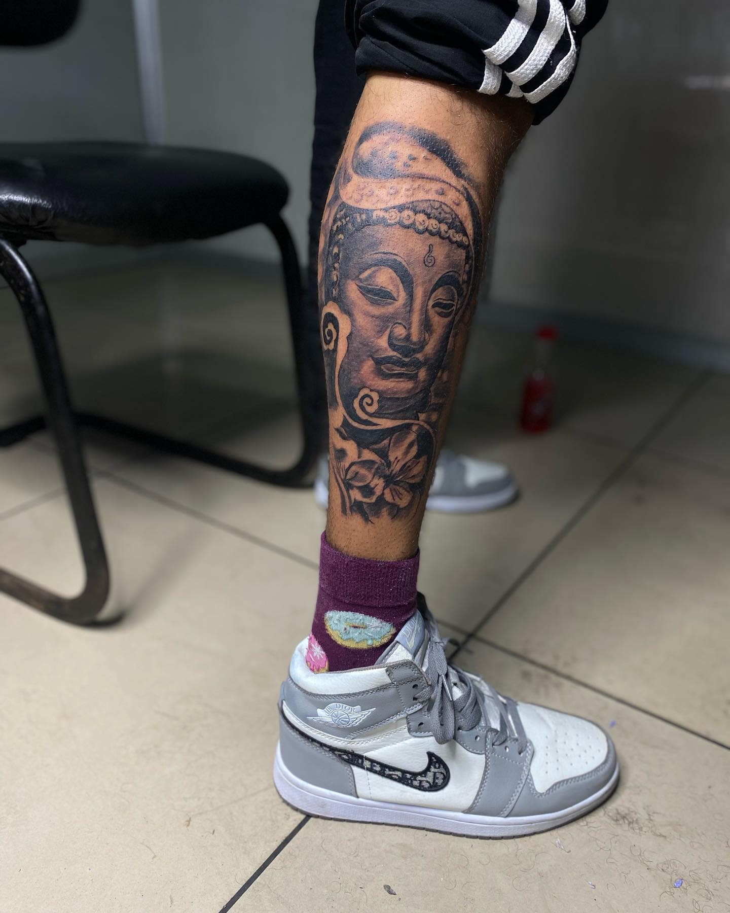 Large Buddha tattoo on a calf