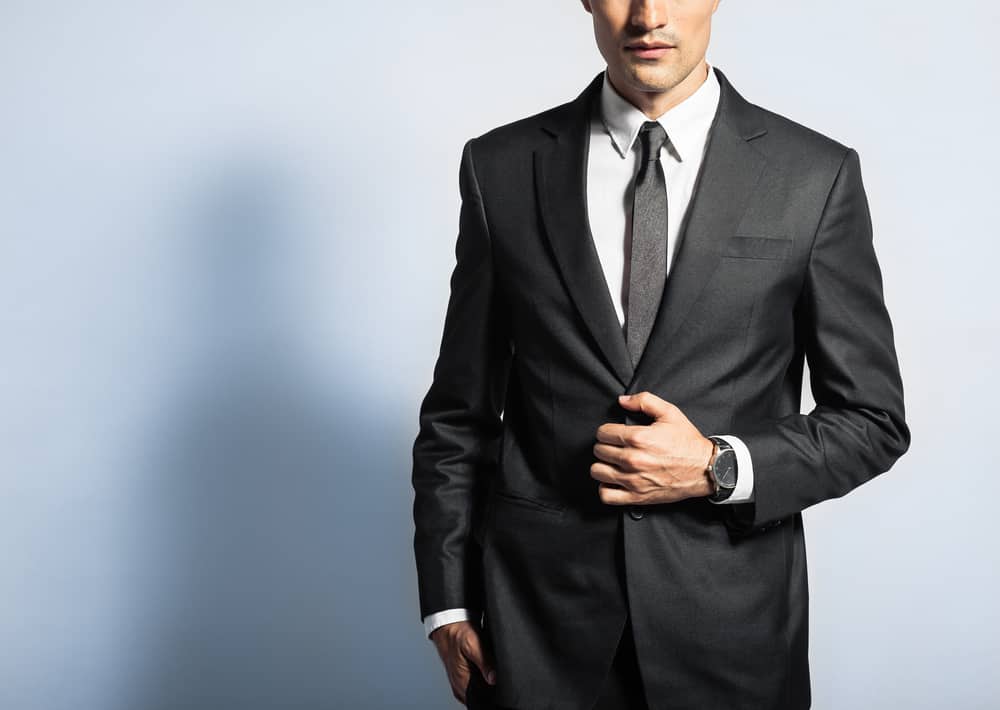 A black suit with a white button-down shirt and a dark colored tie is traditional, but this isn't required. Charcoal, dark gray, and navy suits are good options, as well. 