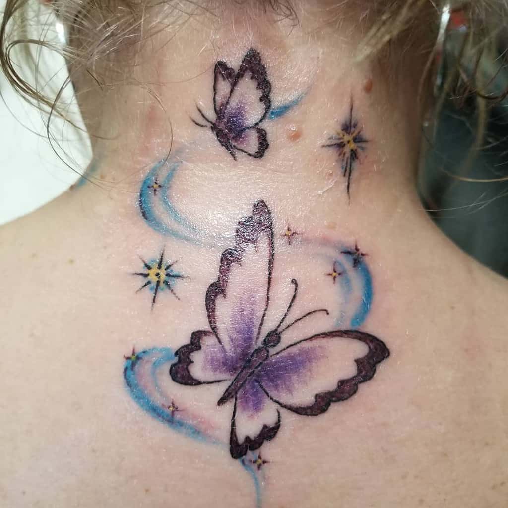 Purple butterflies with blue swirls and stars tattooed on the back of neck