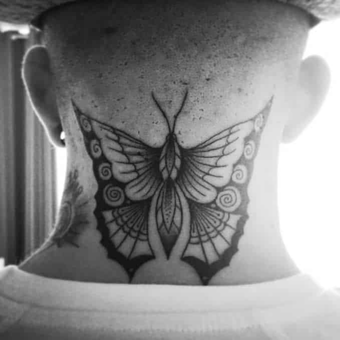 Black and white butterfly tattoo on neck extending to head