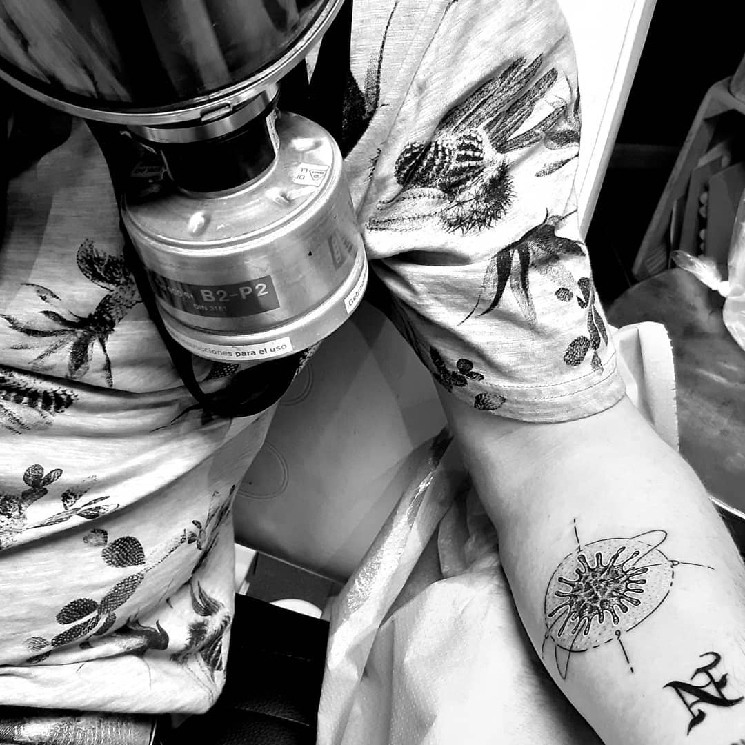 Tattoo of a virus structure on arm