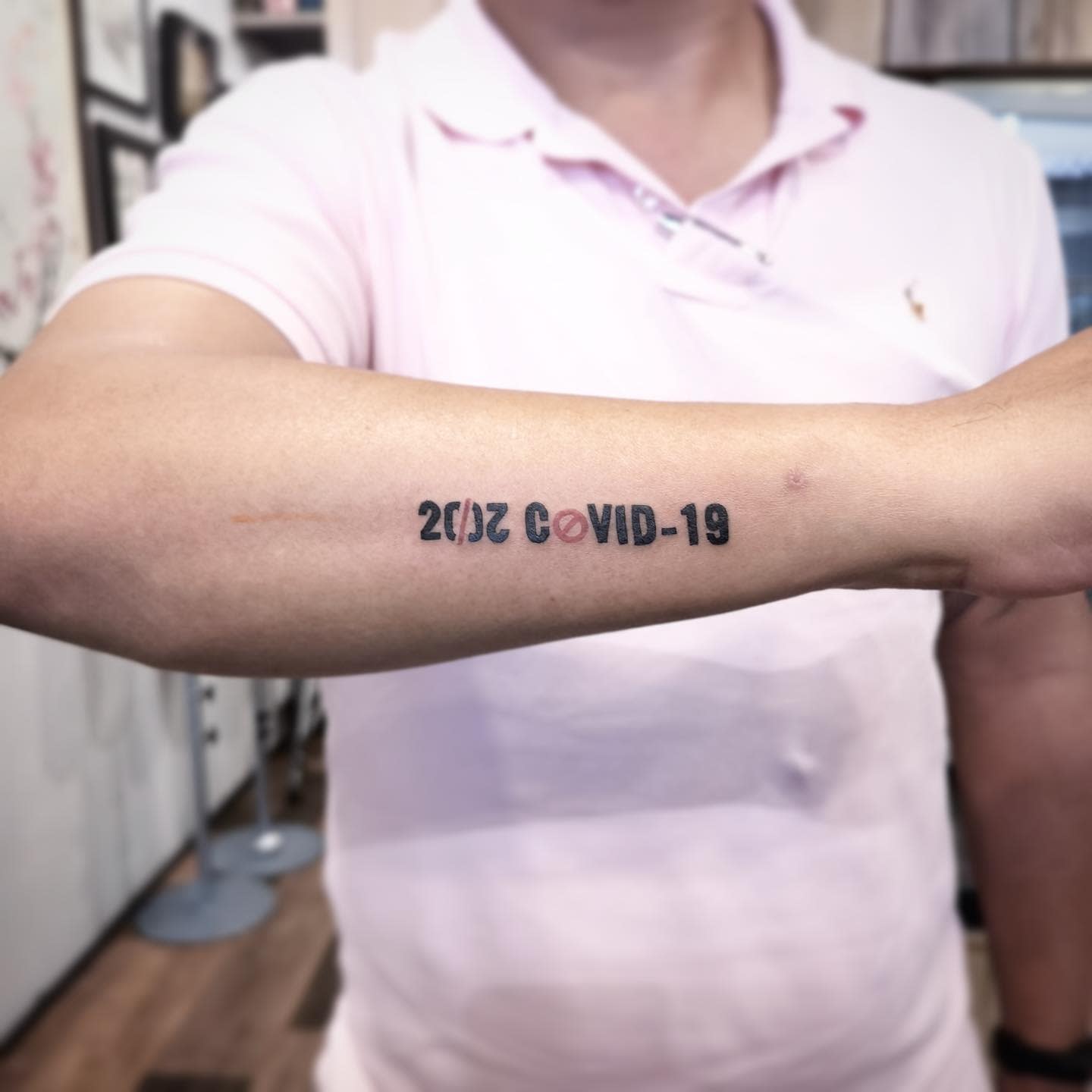 "2020 COVID-19" tattoo on forearm