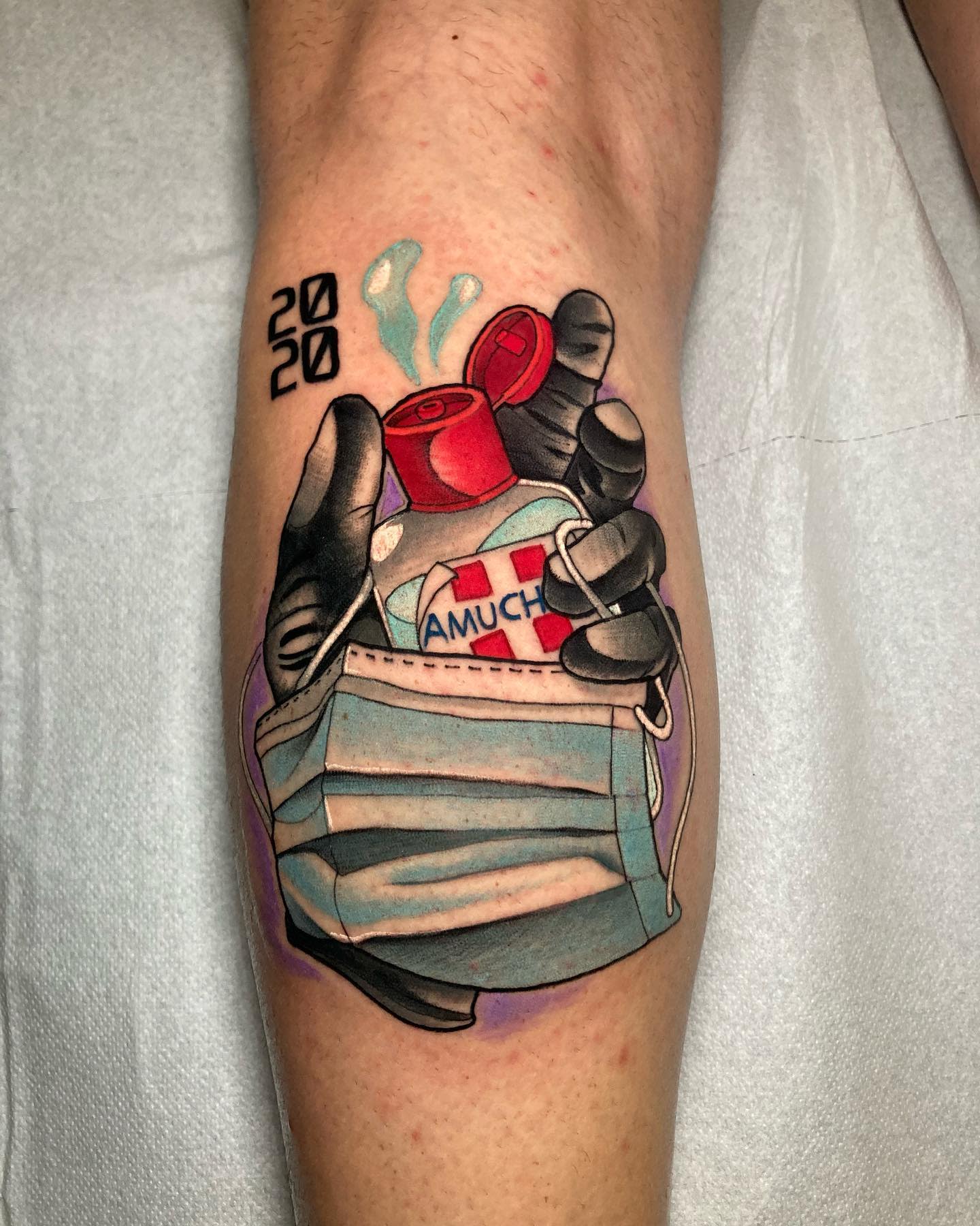 Colorful tattoo of a hand holding sanitizer, mask, and a cross symbol with "2020" text