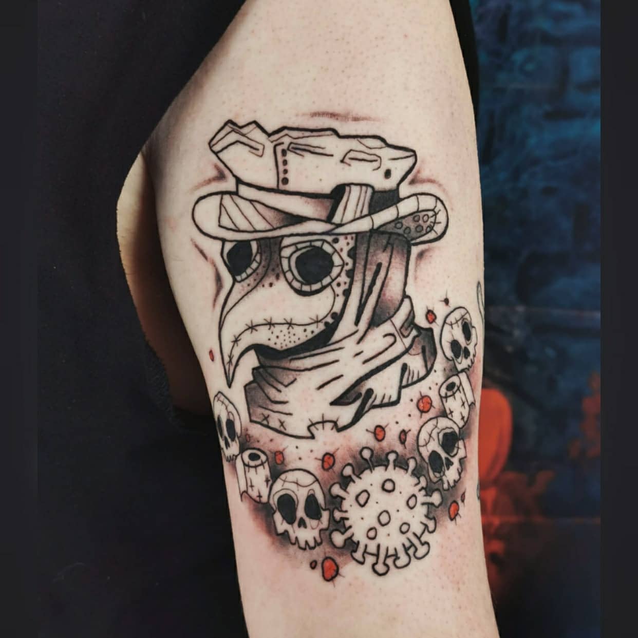 Arm tattoo featuring a plague doctor, skulls, and virus illustration