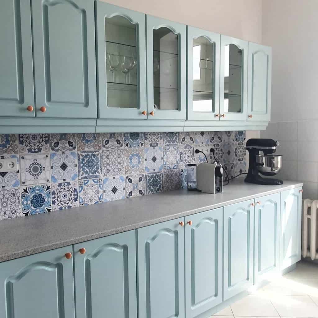 green kitchen cabinets with glass doors blue pattern wall tiles