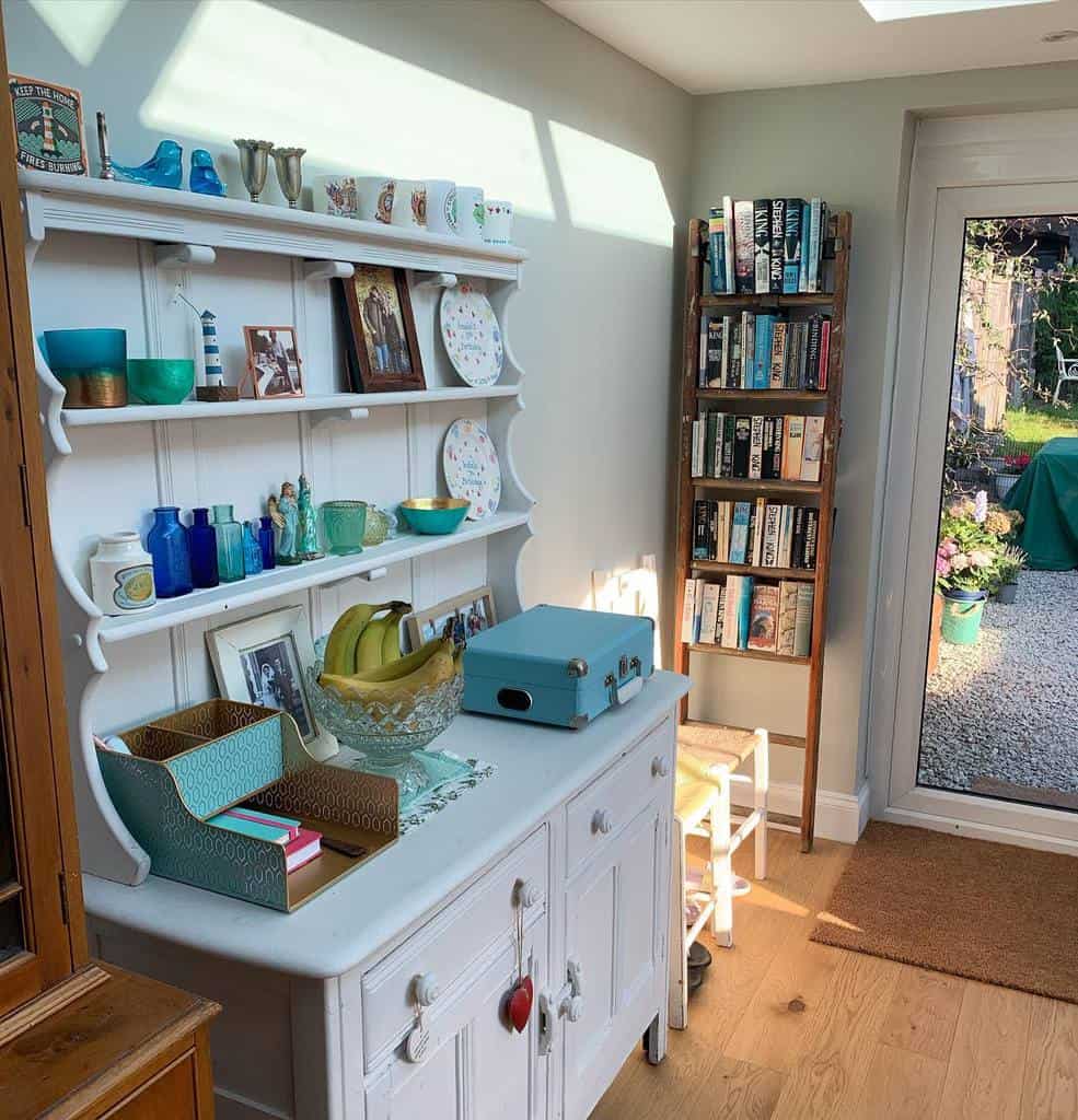 white cabinet with shelving in living room with blue briefcase