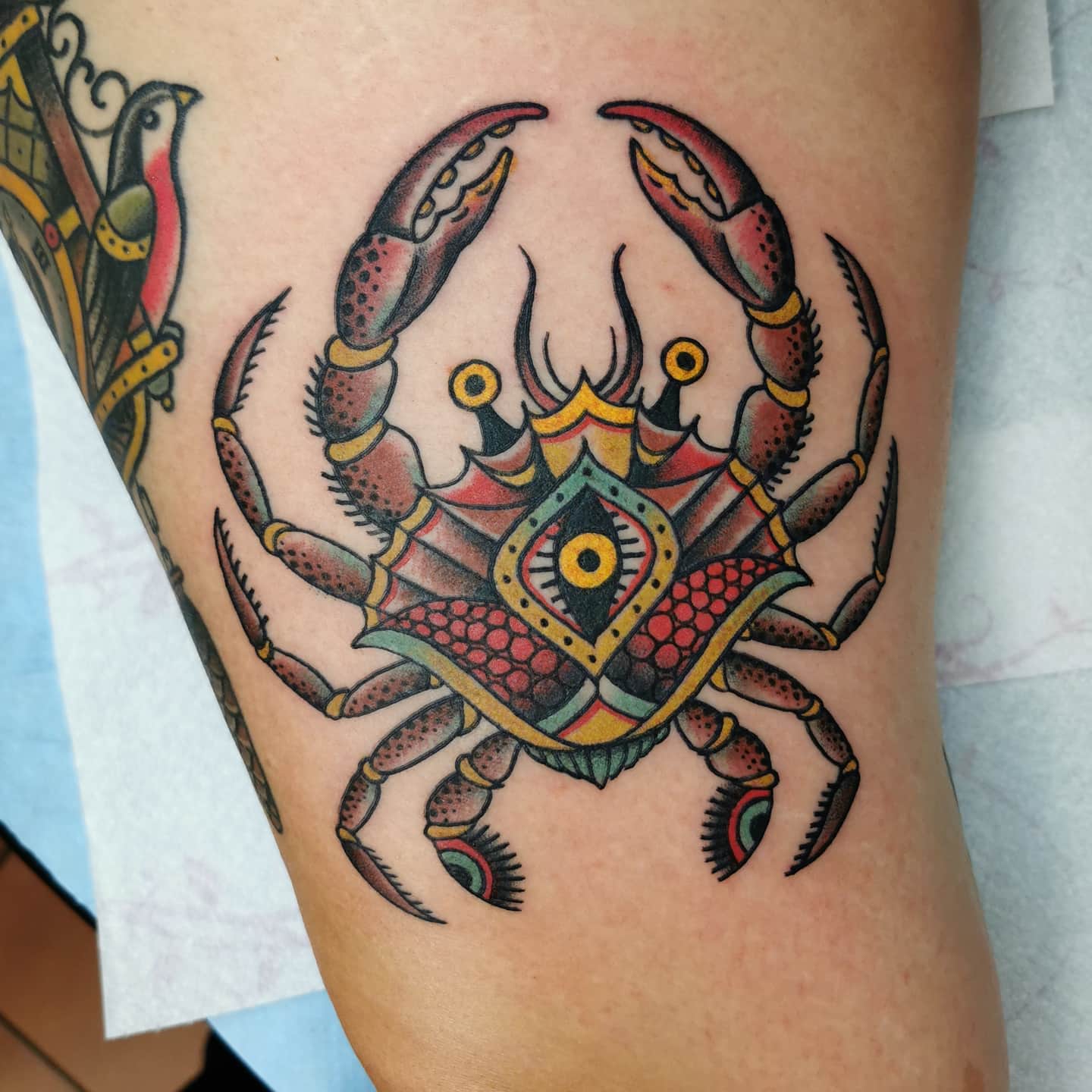 Colorful crab tattoo with intricate geometric patterns on skin