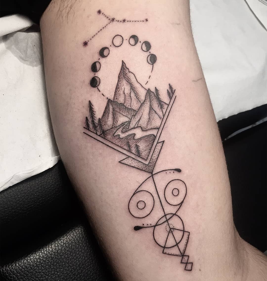 Tattoo of mountains, river, moon phases, geometry and cancer zodiac sign on an arm