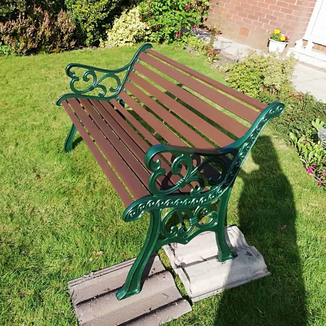 green painted cast iron bench with wood slats