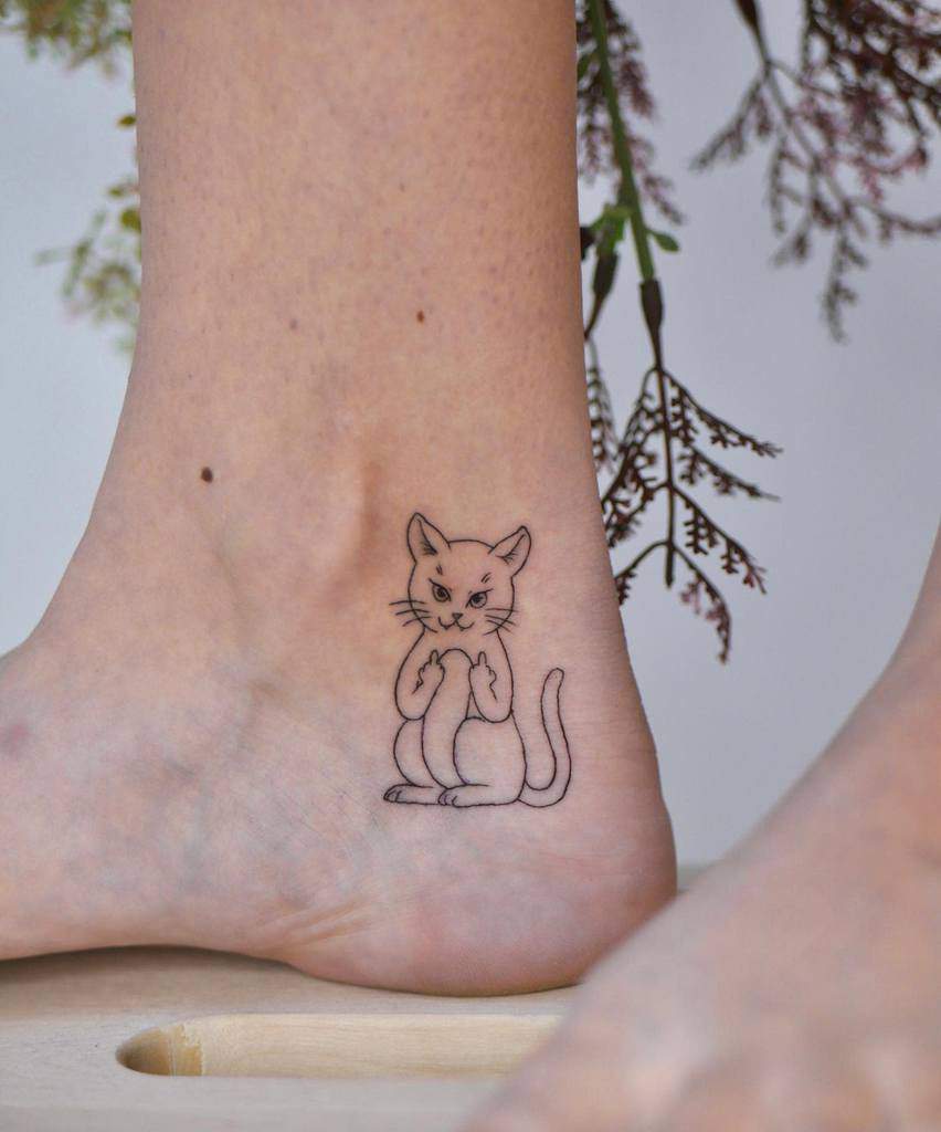 Minimalist angry cat tattoo on ankle