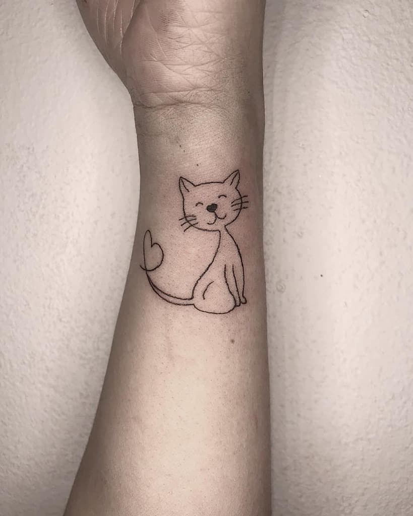 Simple cat tattoo featuring a heart-shaped tail on a wrist