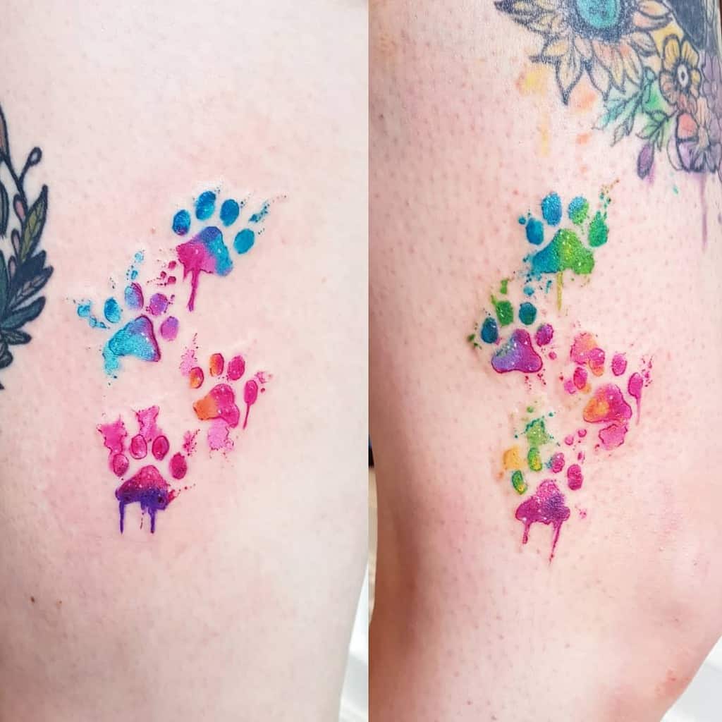 Colorful cat paw print tattoos in bright blues, greens, purples, and pinks