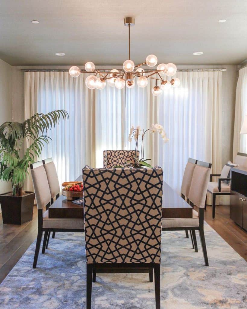 modern dining room table and chairs floor rug sputnik chandelier