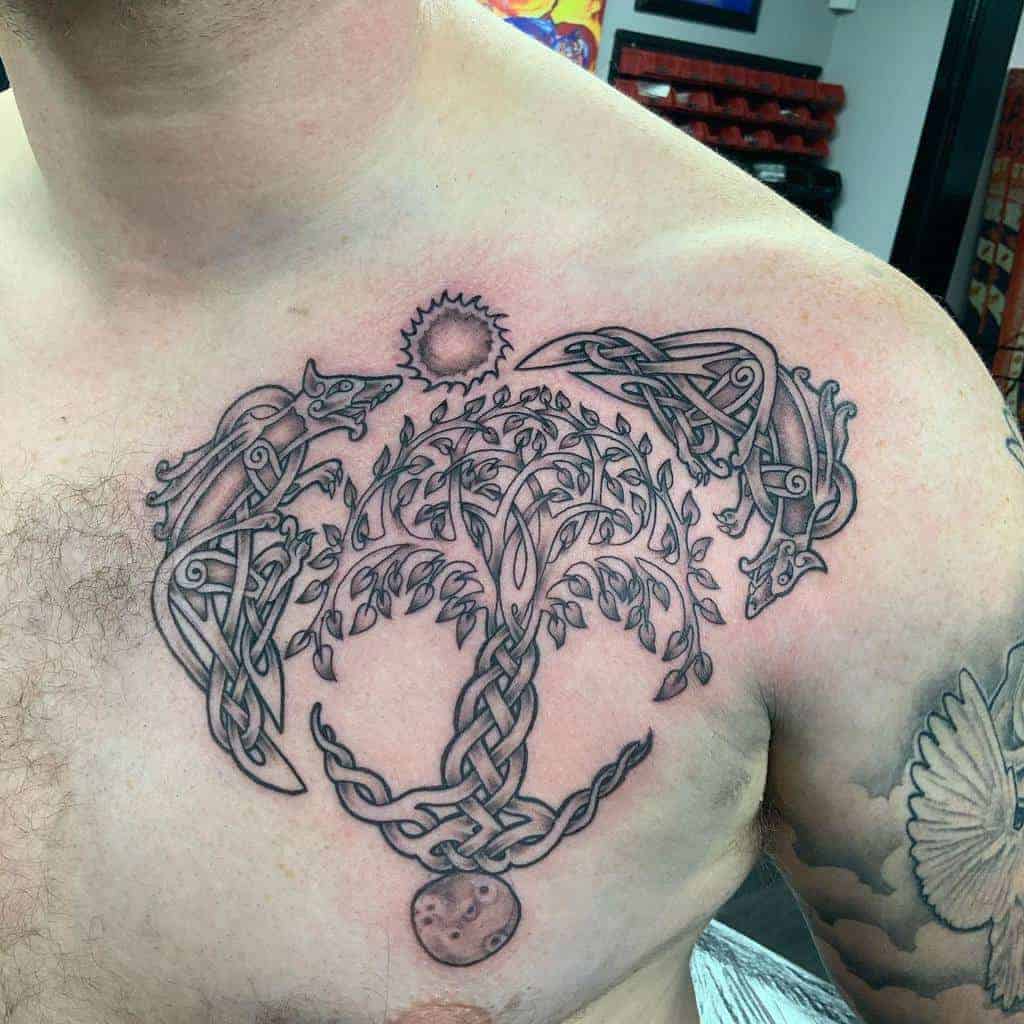Scottish Celtic-style tattoo of Yggdrasil, the Norse tree of life, with knotwork wolves, the sun, and the moon