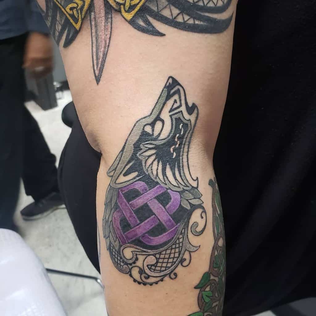 Black Scottish wolf head with Celtic-inspired purple knot design, ornate swirls, and intricate shading