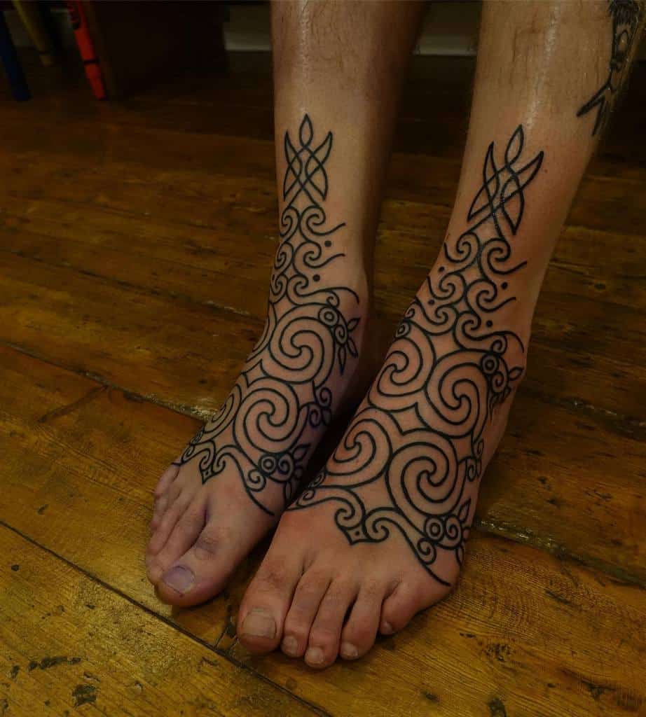 Ornate black ink Scottish tattoos featuring symmetrical Celtic-inspired swirling patterns and interwoven knotwork