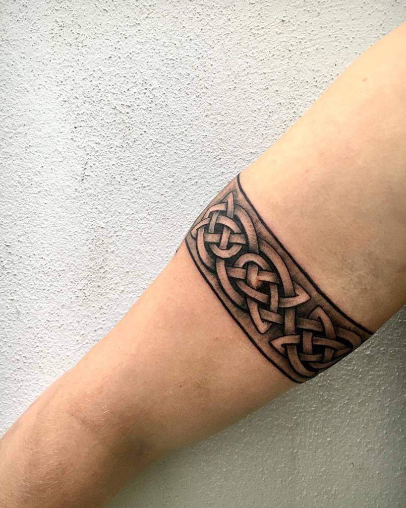 Celtic knot armband tattoo on an upper arm