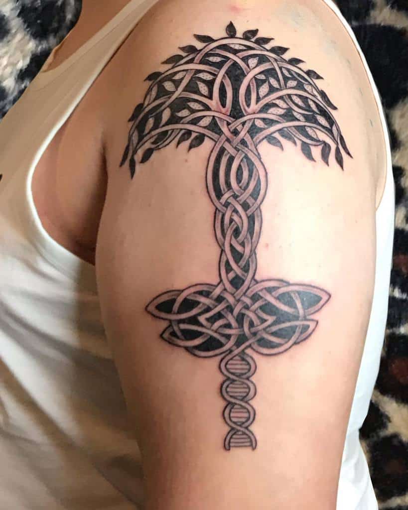 A Celtic tree of life tattoo on the upper arm, featuring intricate knotwork forming the trunk, branches, and roots, symbolizing strength and interconnectedness