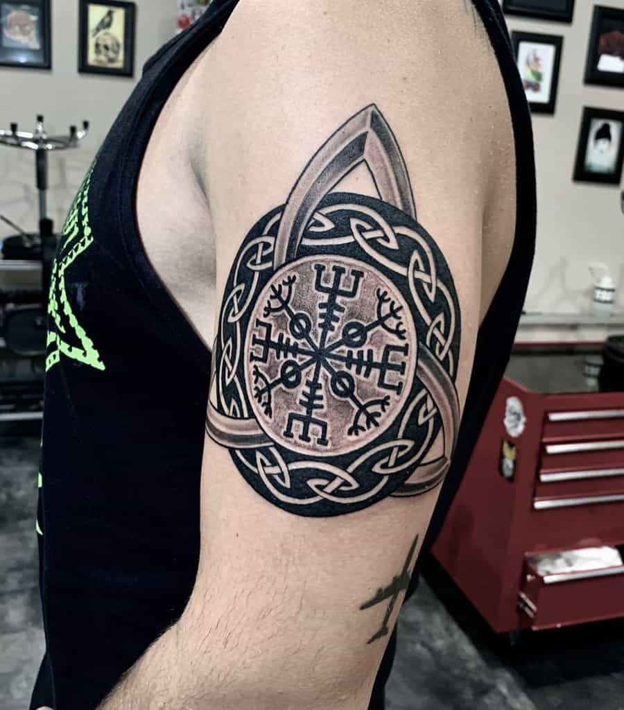 Arm tattoo featuring a Vegvisir symbol with intricate knotwork design and a Valknut emblem on the shoulder