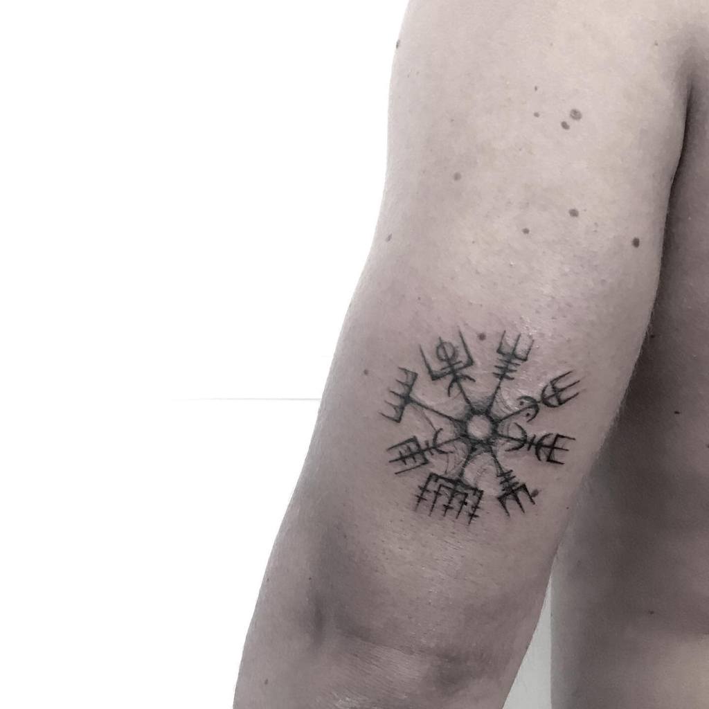 Tattoo of a Vegvisir symbol on an upper arm