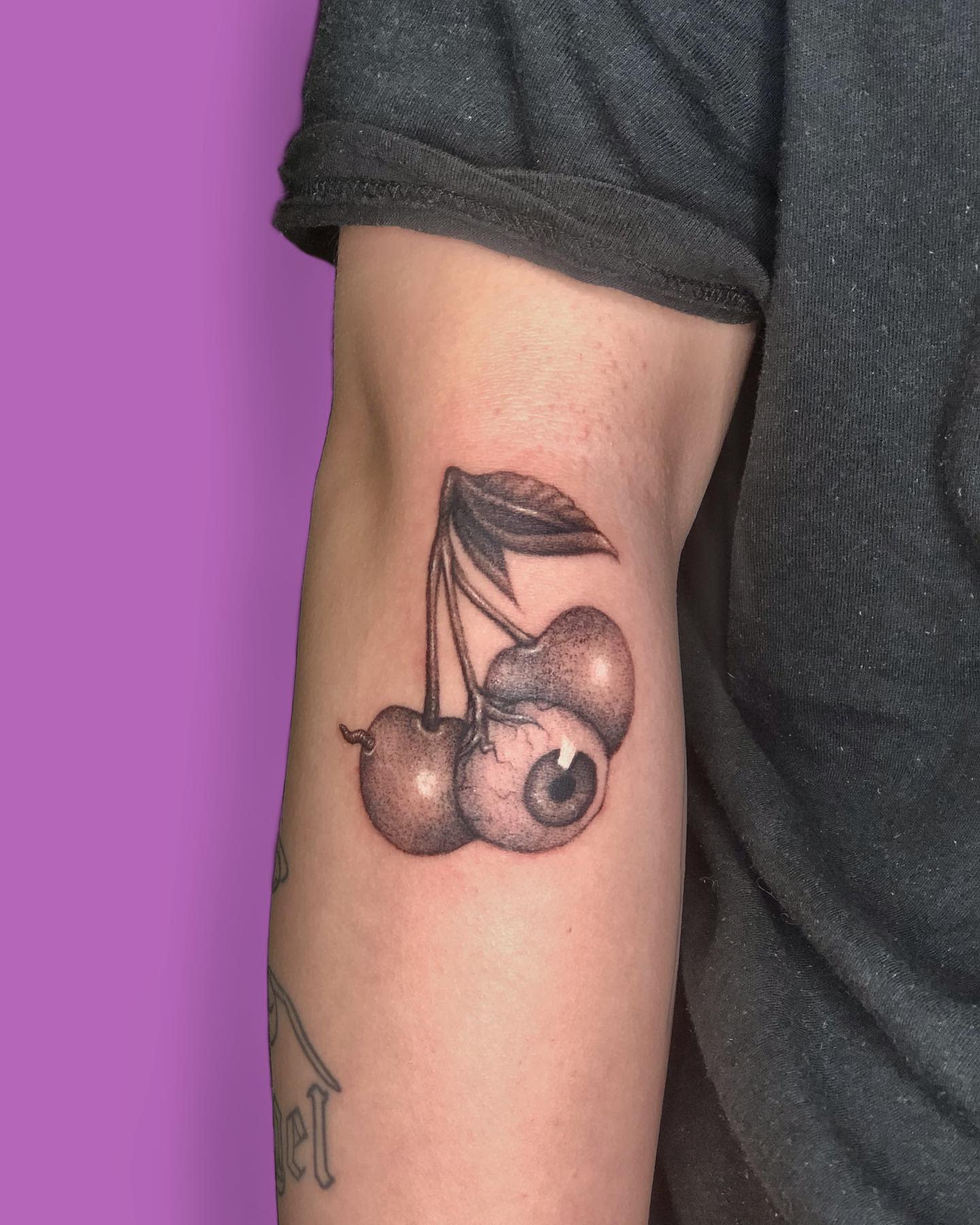 Arm Cherry Tattoo-nartka.art Tattoo of cherries with one cherry depicted as an eyeball on an arm
