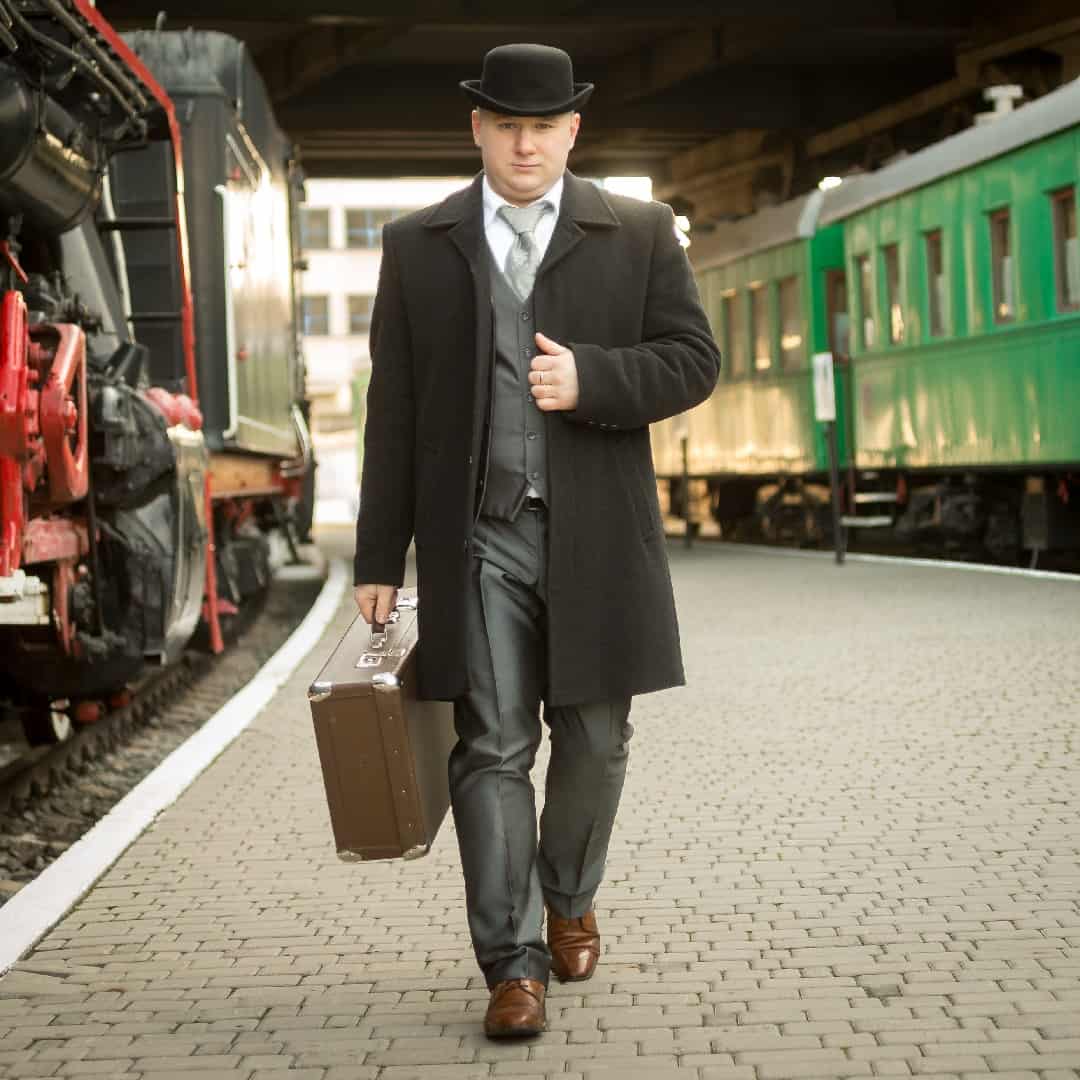 Handsome,Man,In,Retro,Suit,With,Suitcase,Walking,On,The