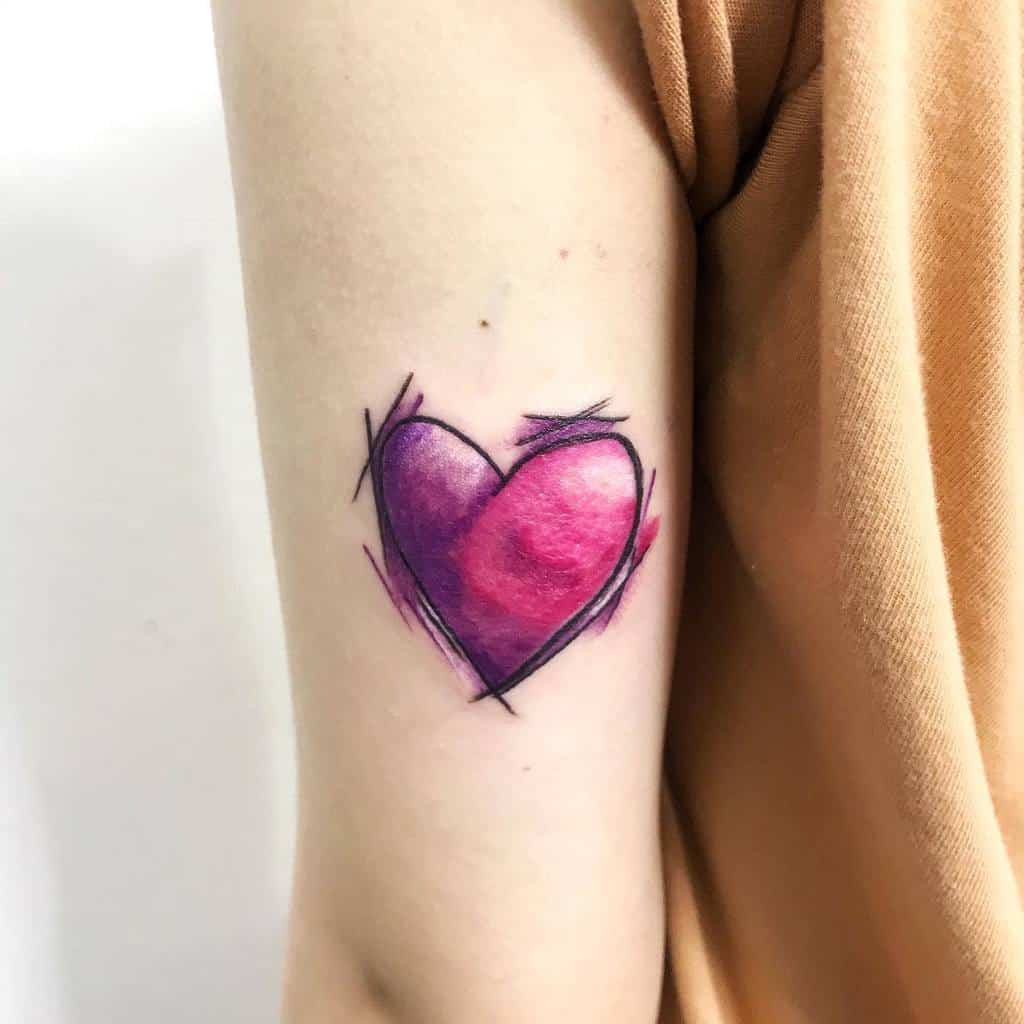 Vibrant pink and purple heart tattoo on the arm, designed with a sketch-style outline