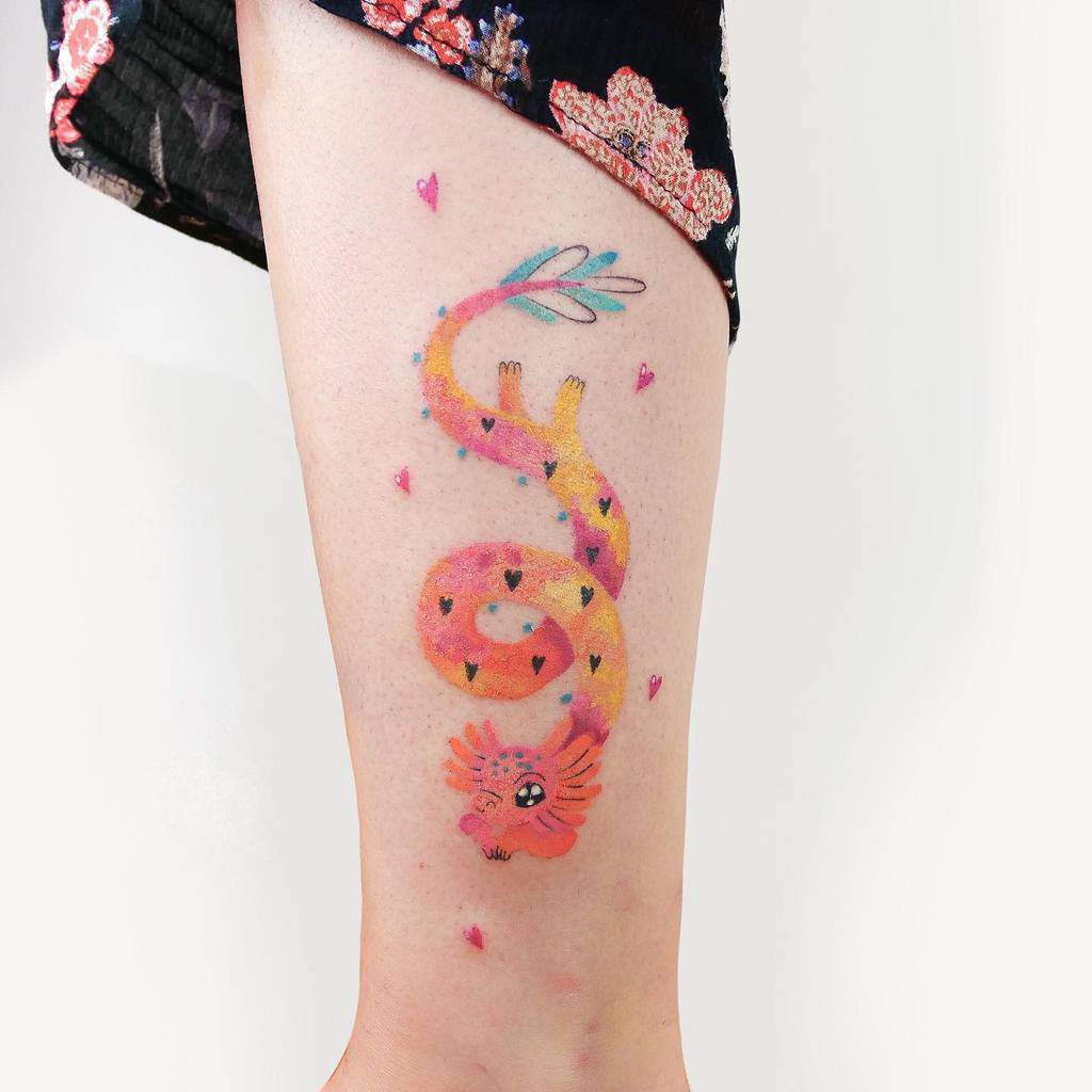 Colorful dragon tattoo with heartsl, surrounded by small pink hearts